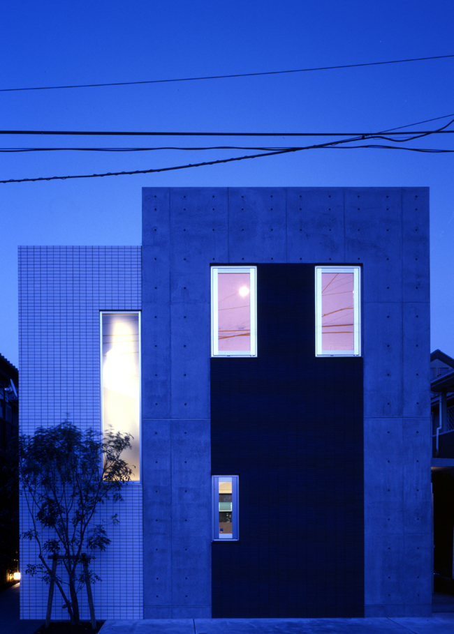 コンクリート住宅の夜の佇まい。3層あるコンクリートの箱を1層分地下に沈めたような設計となりました。